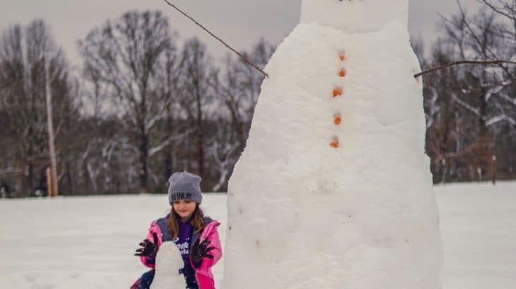 a girl building a snowman