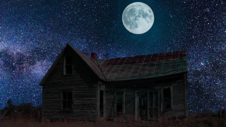 an old spooky house in the country under a full moon
