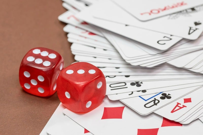 red dice and a pack of cards