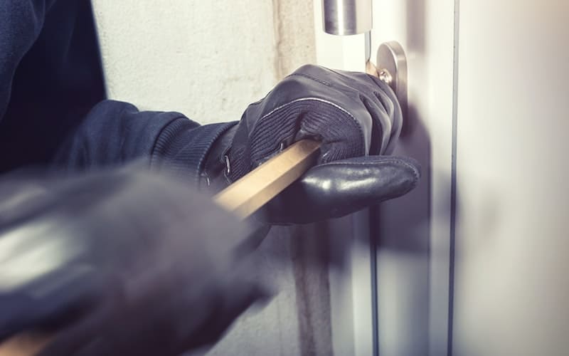 burglar trying to open a door