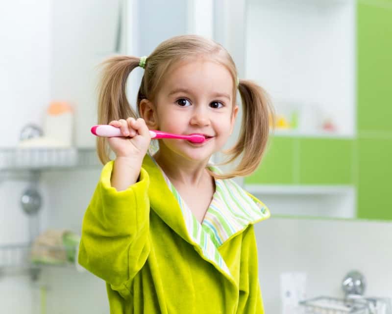 girl with a pink toothbrush