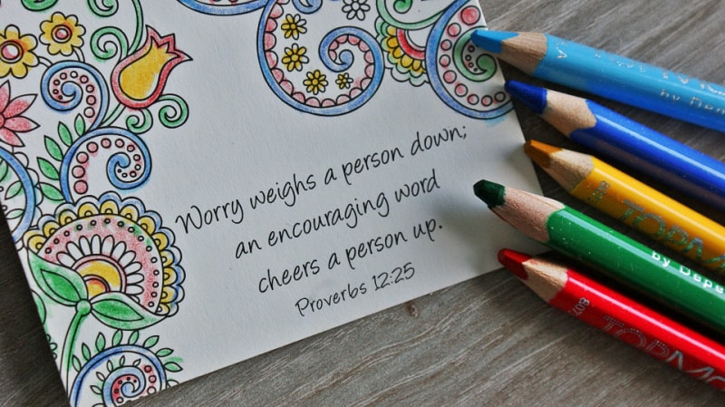 a Christian coloring page and colored pencils