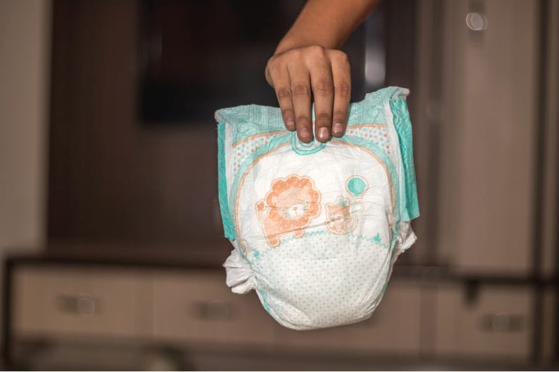 a child holding a pull up diaper