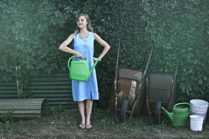 woman with watering can and wheelbarrows