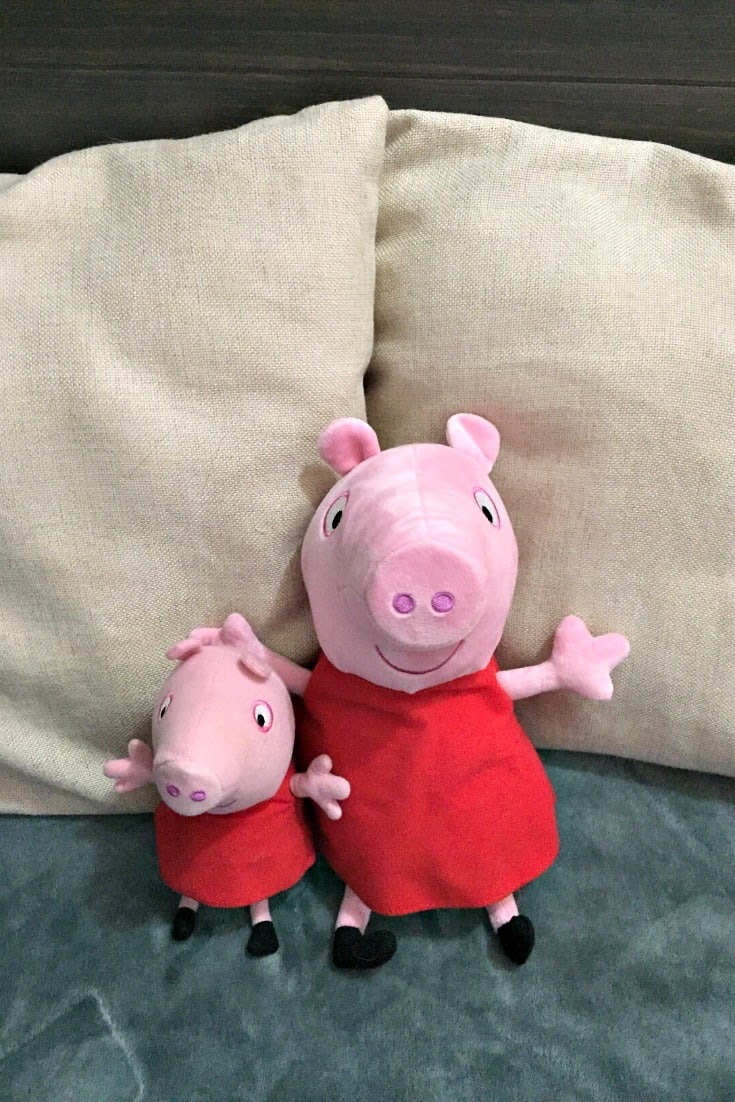 two peppa pig dolls on the bed