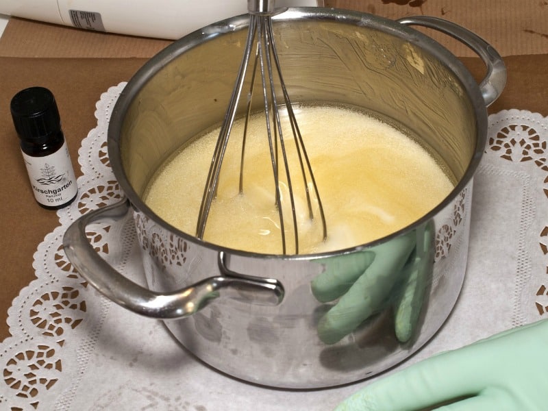 stirring the soap mixture with a whisk