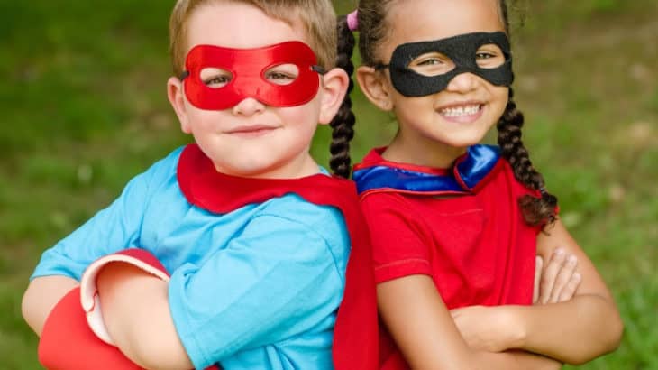 two children wearing homemade capes and masks for dress up