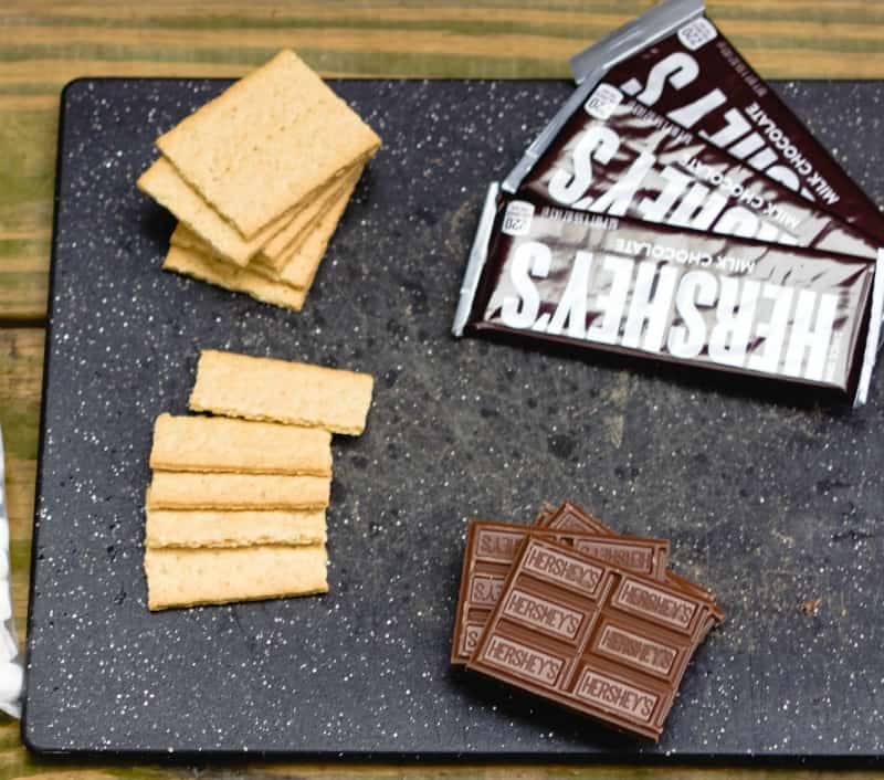graham crackers and Hershey bars on a black tray