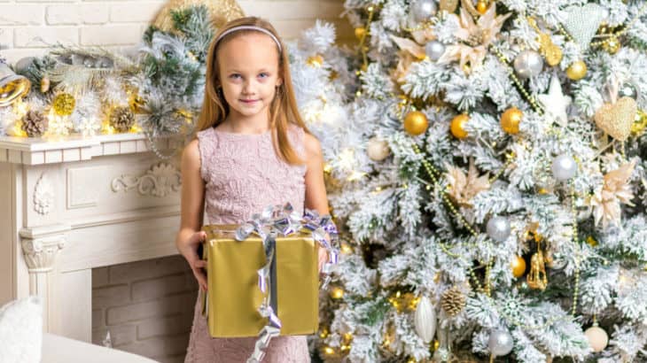 a girl holding a gold present