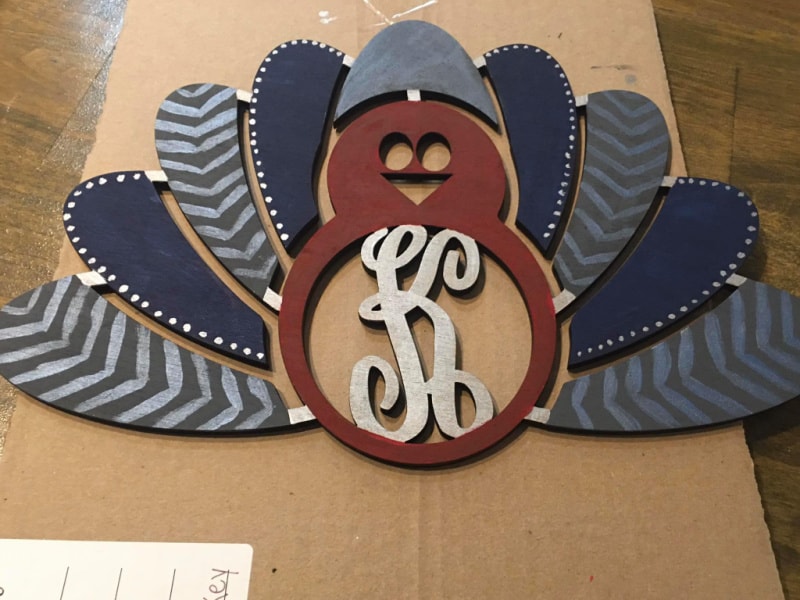 a turkey cutout that was painted blue and rust colors