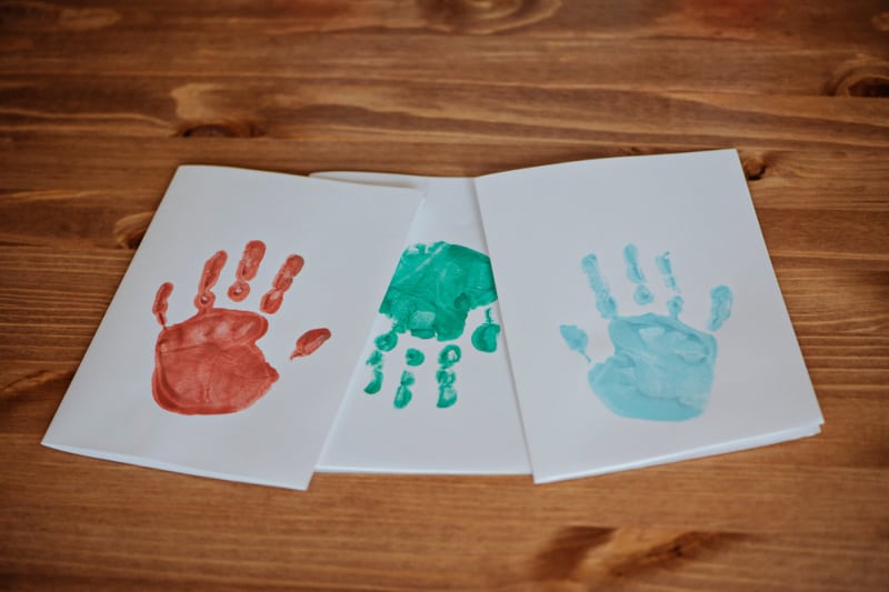 cards with different colored hand prints on them