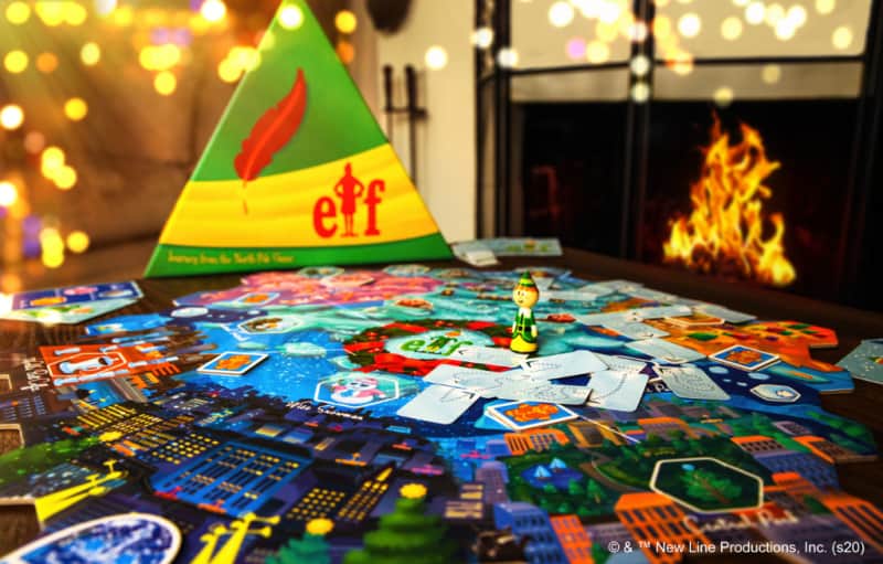 board game set up in front of a Christmas tree and fireplace