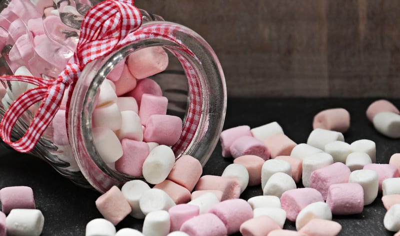 a jar of pink and white marshmallows