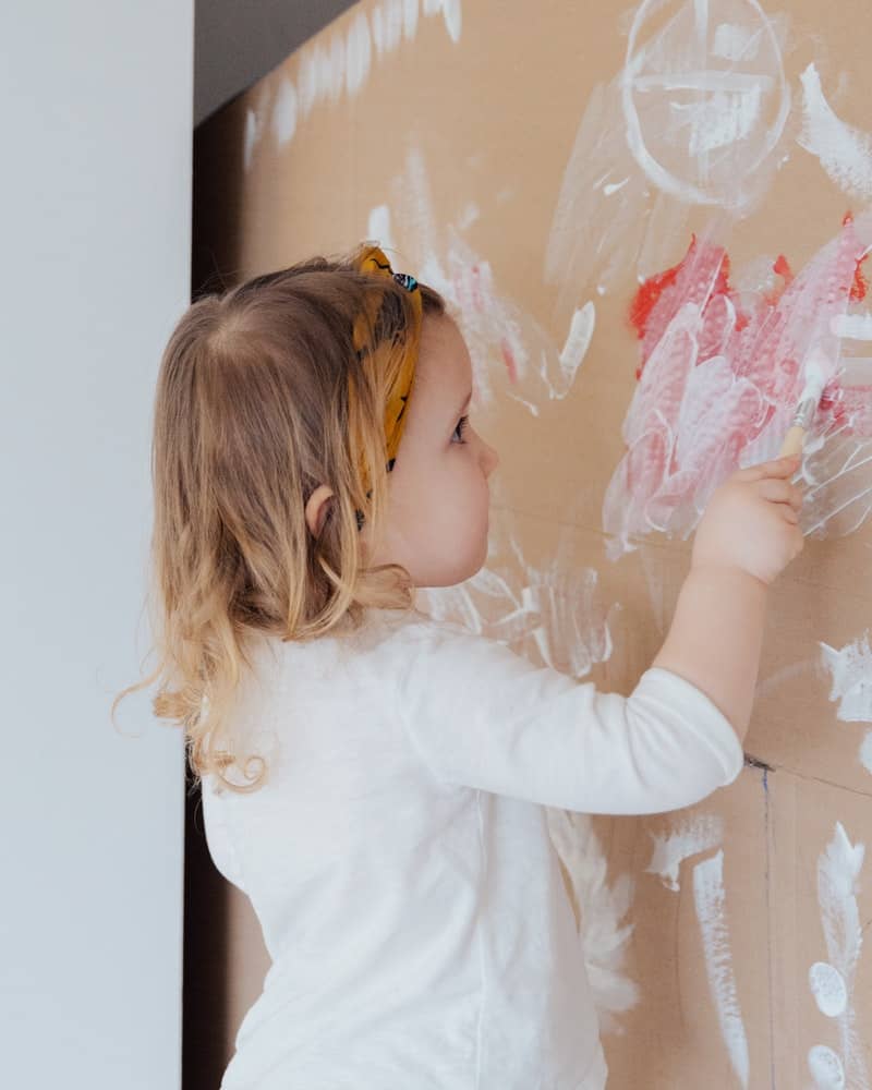 little girl finger painting