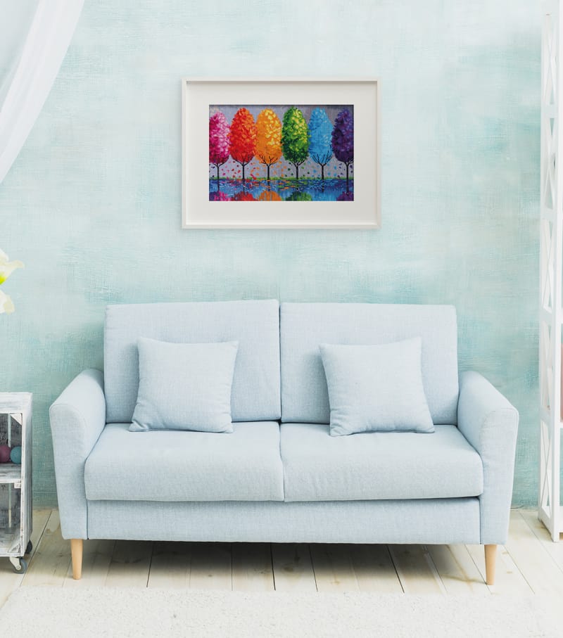 a white couch with a diamond art painting above it on the wall