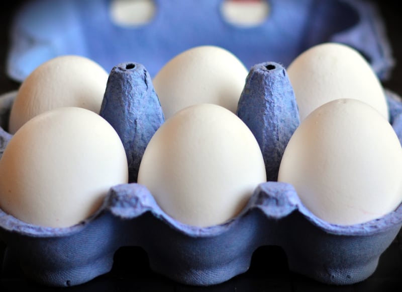 white Easter eggs in a blue carton