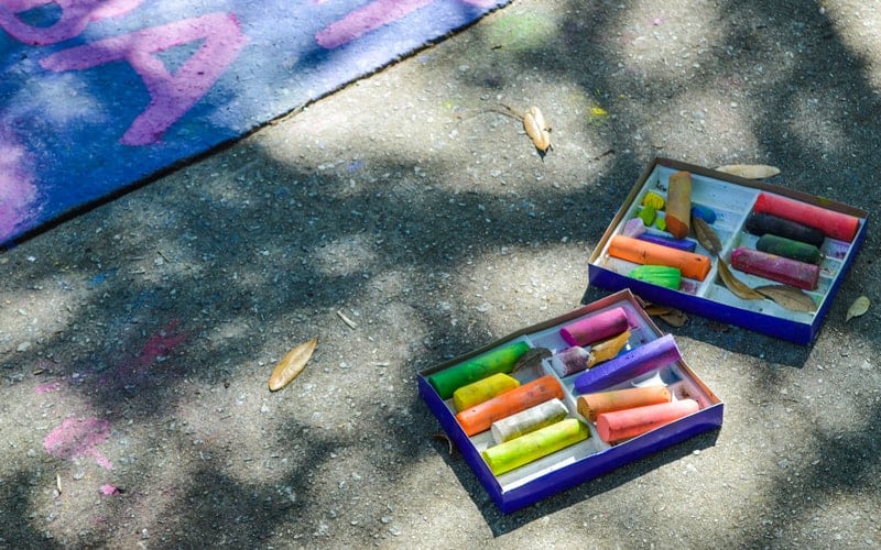 a package of sidewalk chalk on the sidebalk