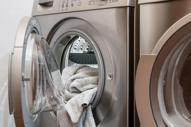 a washer and dryer with a towel
