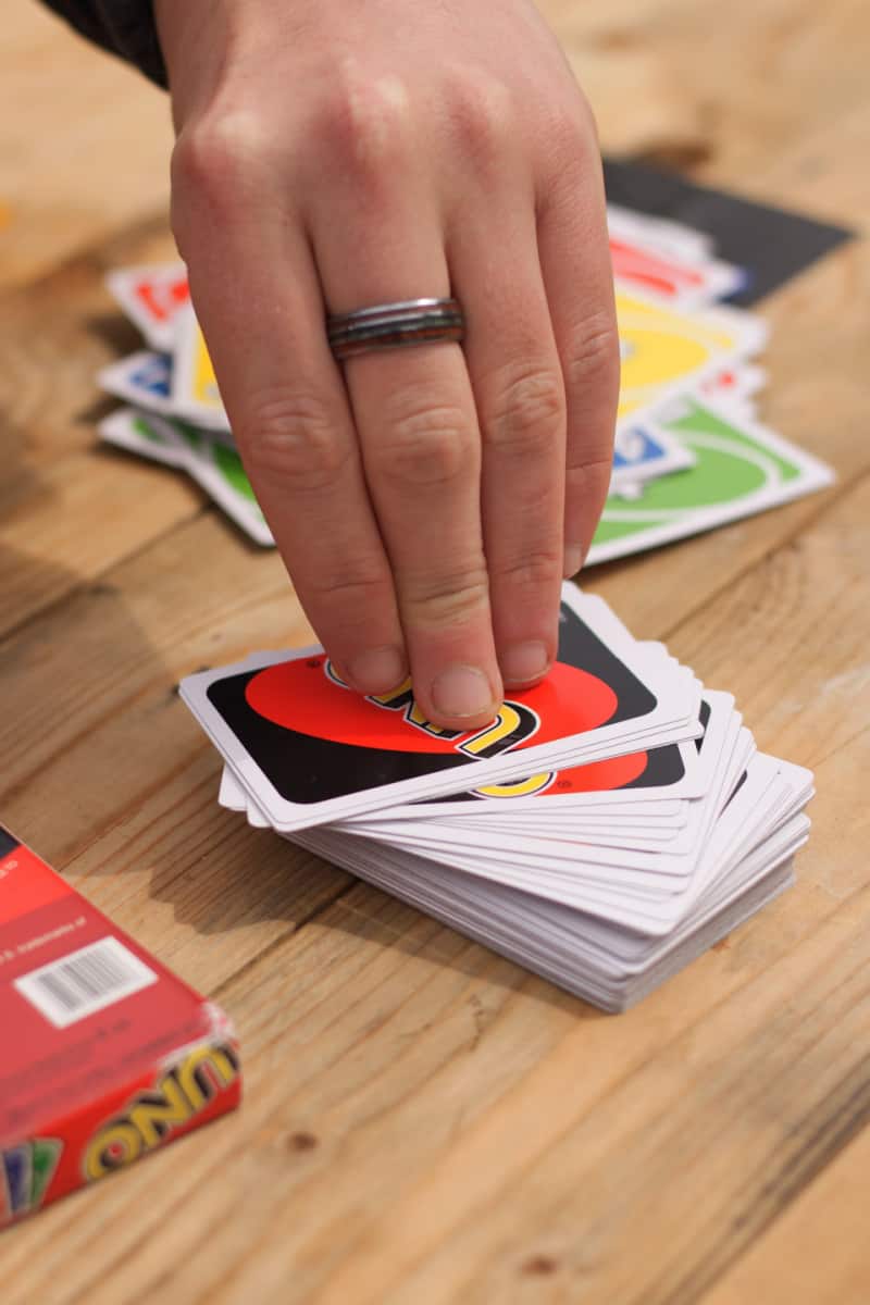 a hand lifting a card off the deck