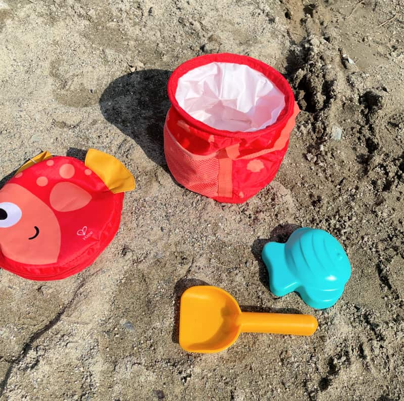 This collapsible beach pail set with toys is perfect for a day at the beach. It includes a carrying case, bucket, shovel, and sand toy! This set can be stored in your car or home easily because it collapses down to just a few inches tall when not in use.
