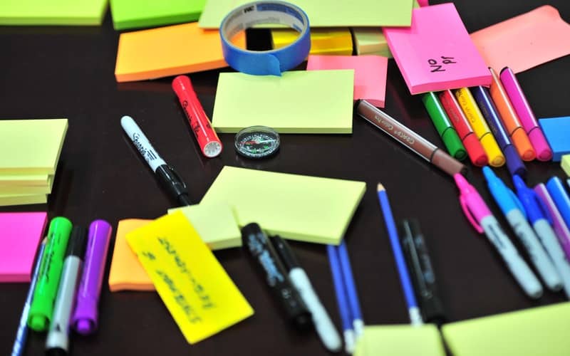 colorful post it notes and markers on a desk