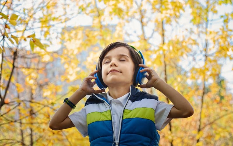 a boy listening to music on his headphones