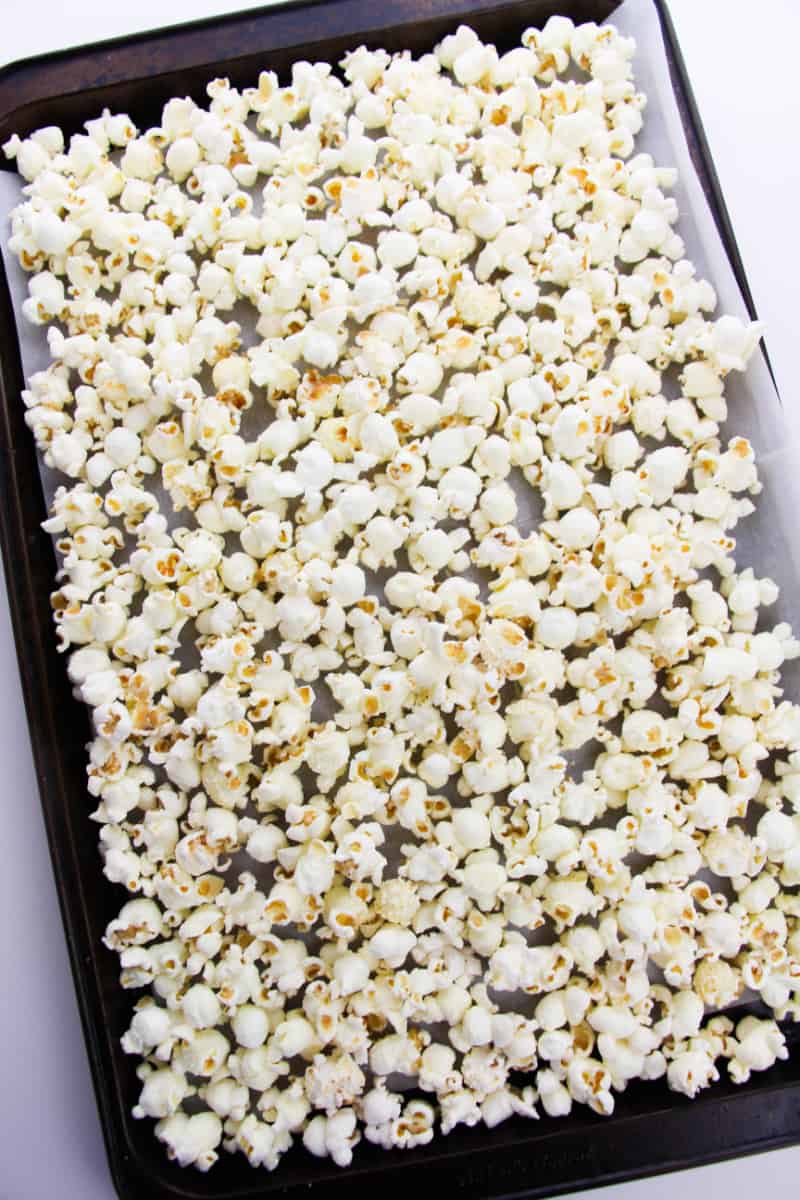 popcorn spread out on a cookie sheet