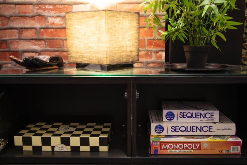 a shelving unit with boxes of games