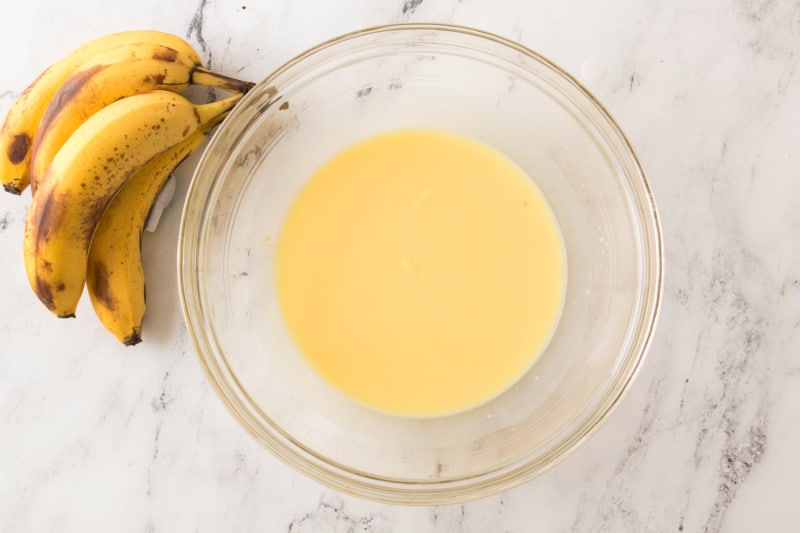 banana pudding in a bowl near bananas
