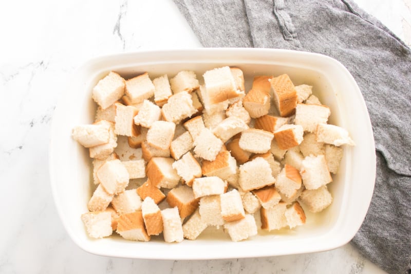 bread cubes in a white baking dish