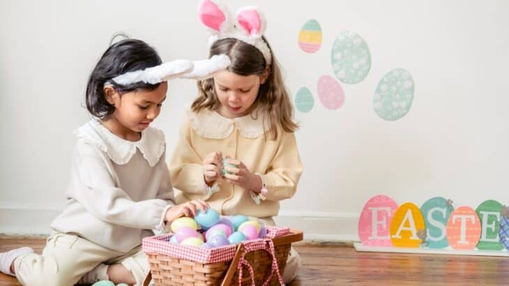 two children looking through Easter basket eggs