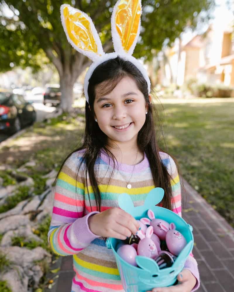a girl holding an Easter Basket with toys