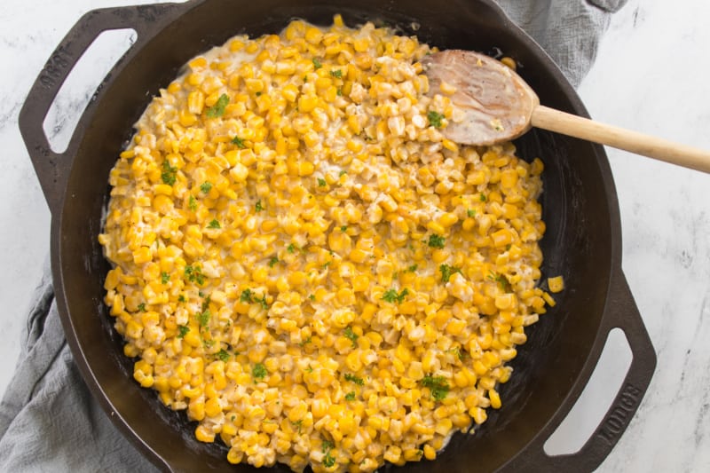 a cast iron skillet with corn in it