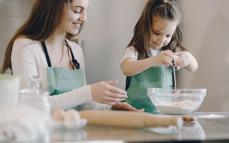 a woman baking with her daughter