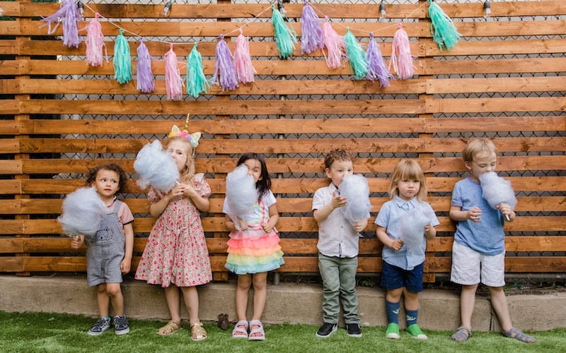 children eating cotton candy at a party