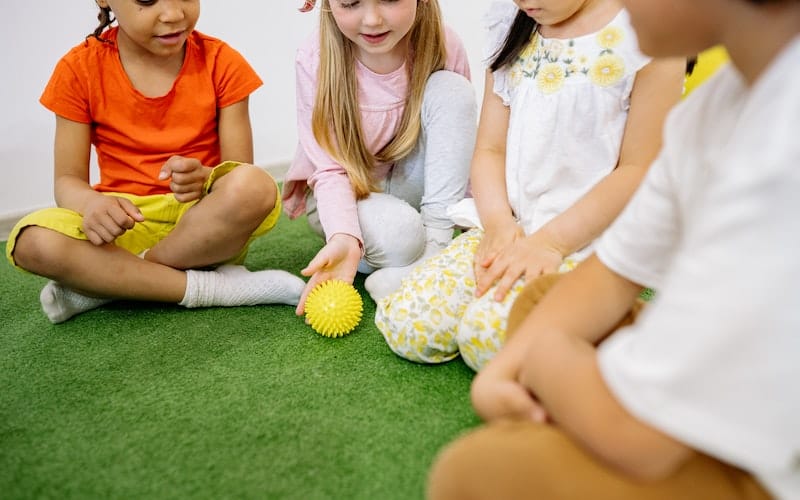 children playing with a sensory ball