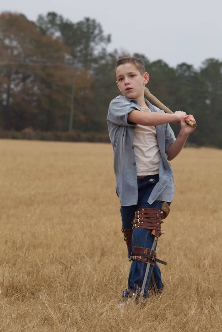 boy playing baseball with a leg bracelet