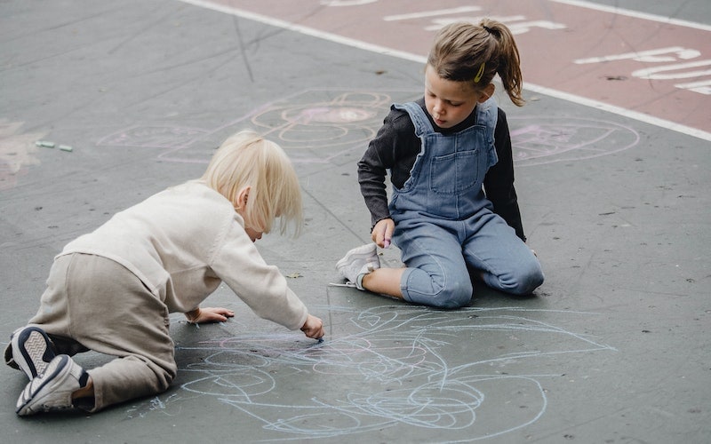 little children doodling with chalk