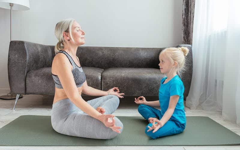 woman and child practicing yoga