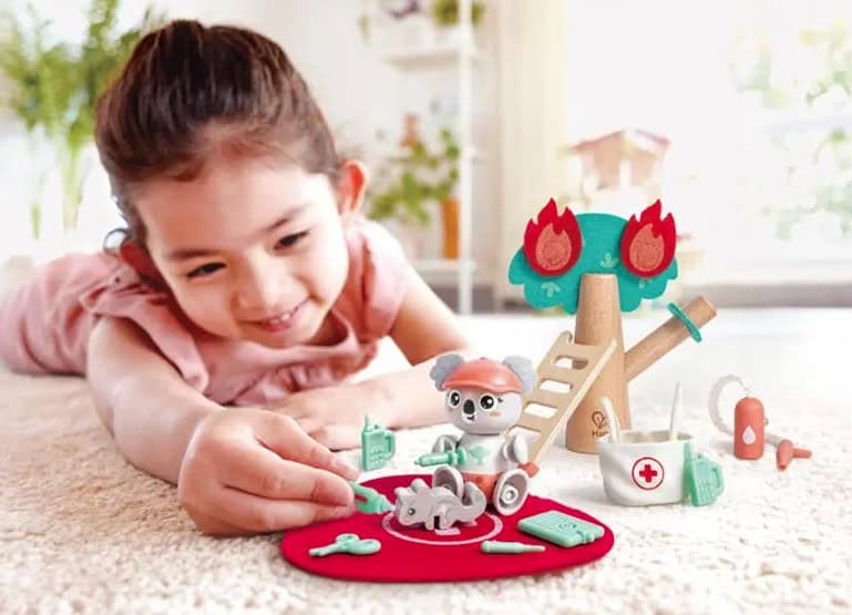 girl playing with wooden toys