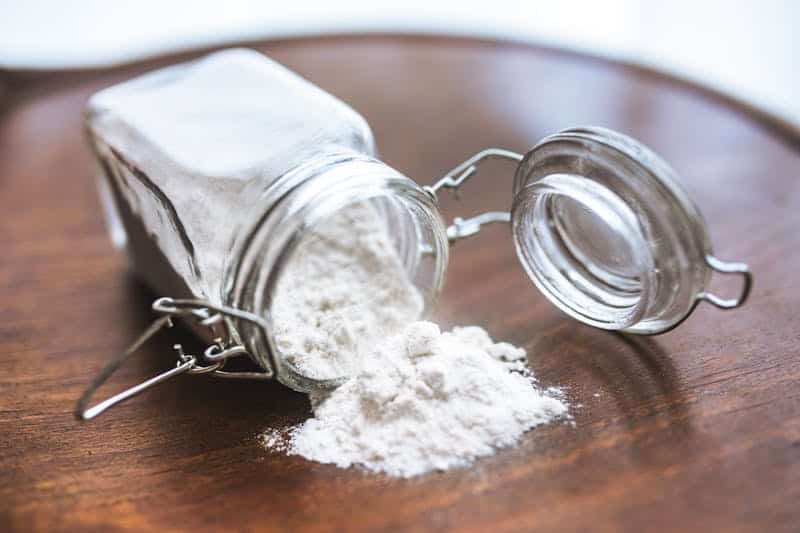 baking soda spilling out of a glass jar