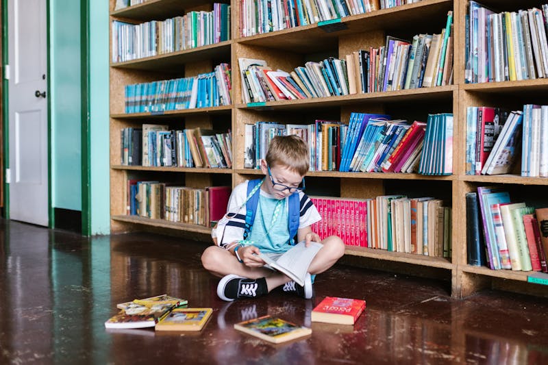 child reading books in the library