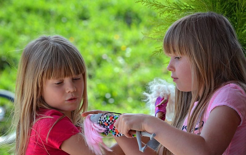 girls playing with Barbie dolls