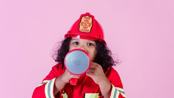 cute little girl in a fire fighters suit