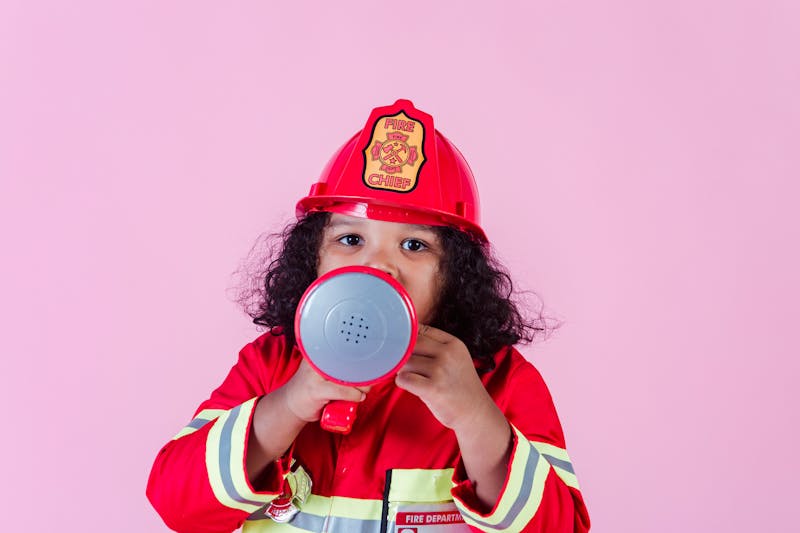 cute little girl in a fire fighters suit