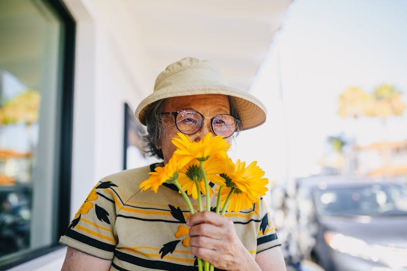 grandmother smelling flowers