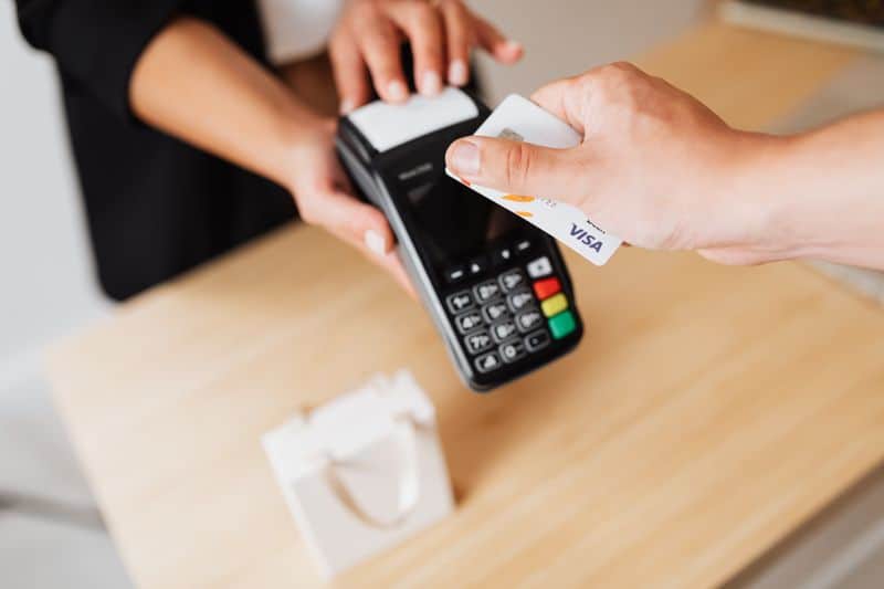 person using credit card at a point of sale terminal