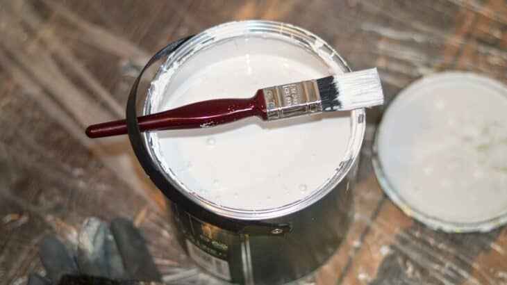 can of paint and paint brush