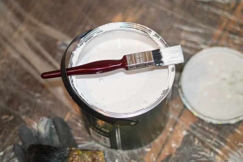 can of paint and paint brush