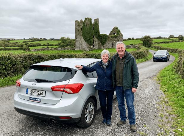 car and castle with a couple in ireland